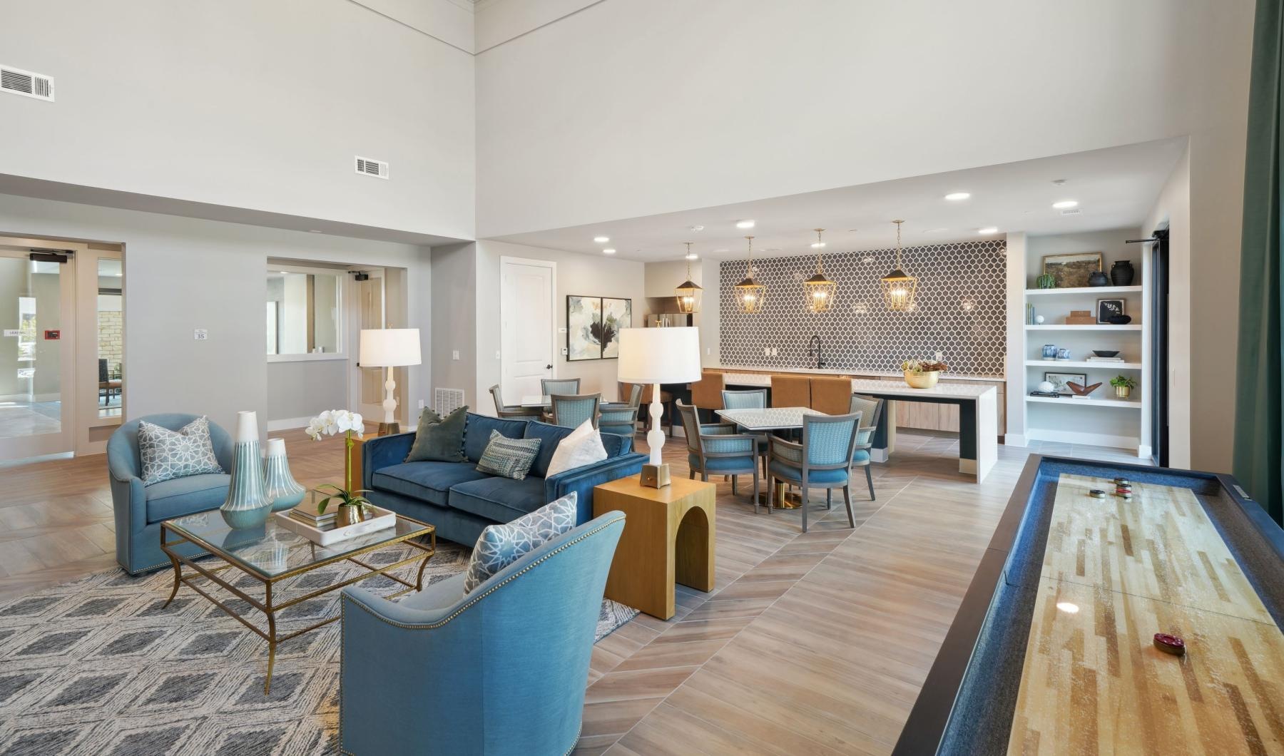 a clubroom with couches, tables and chairs
