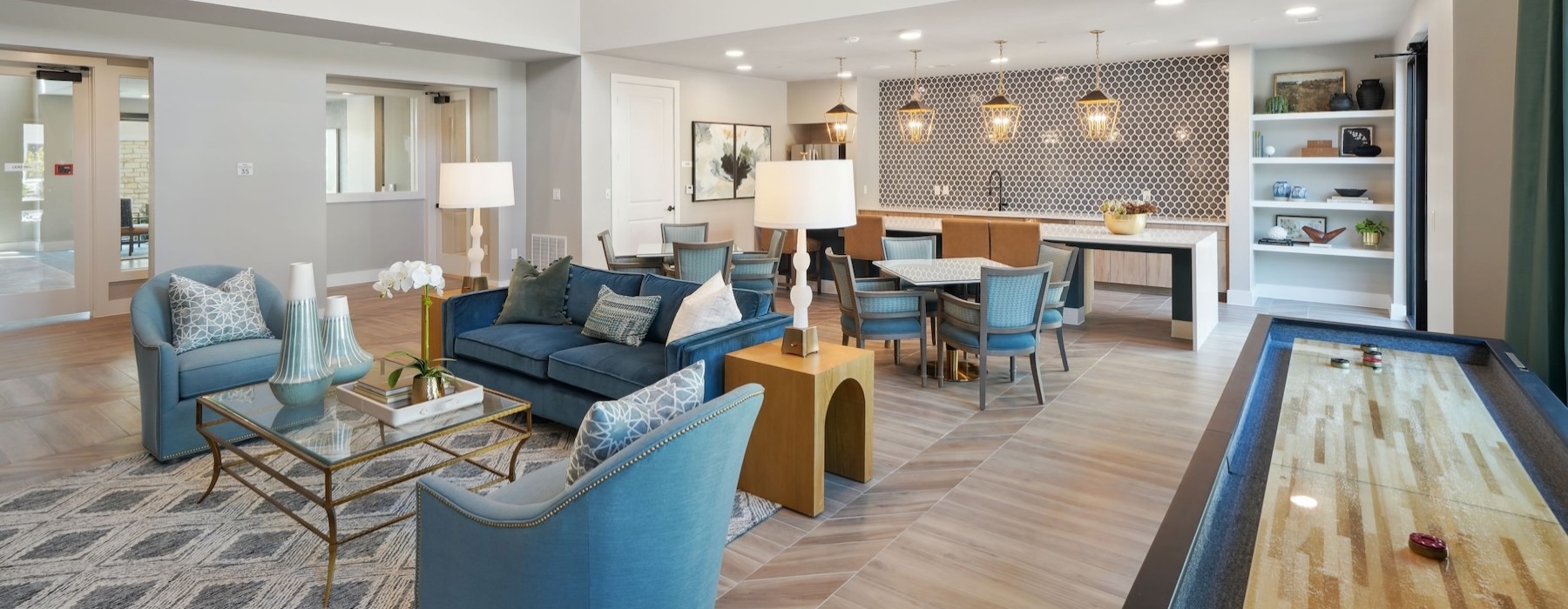 a clubroom with couches, tables and chairs