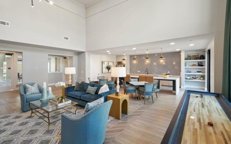 a clubroom with couches, tables and chairs
